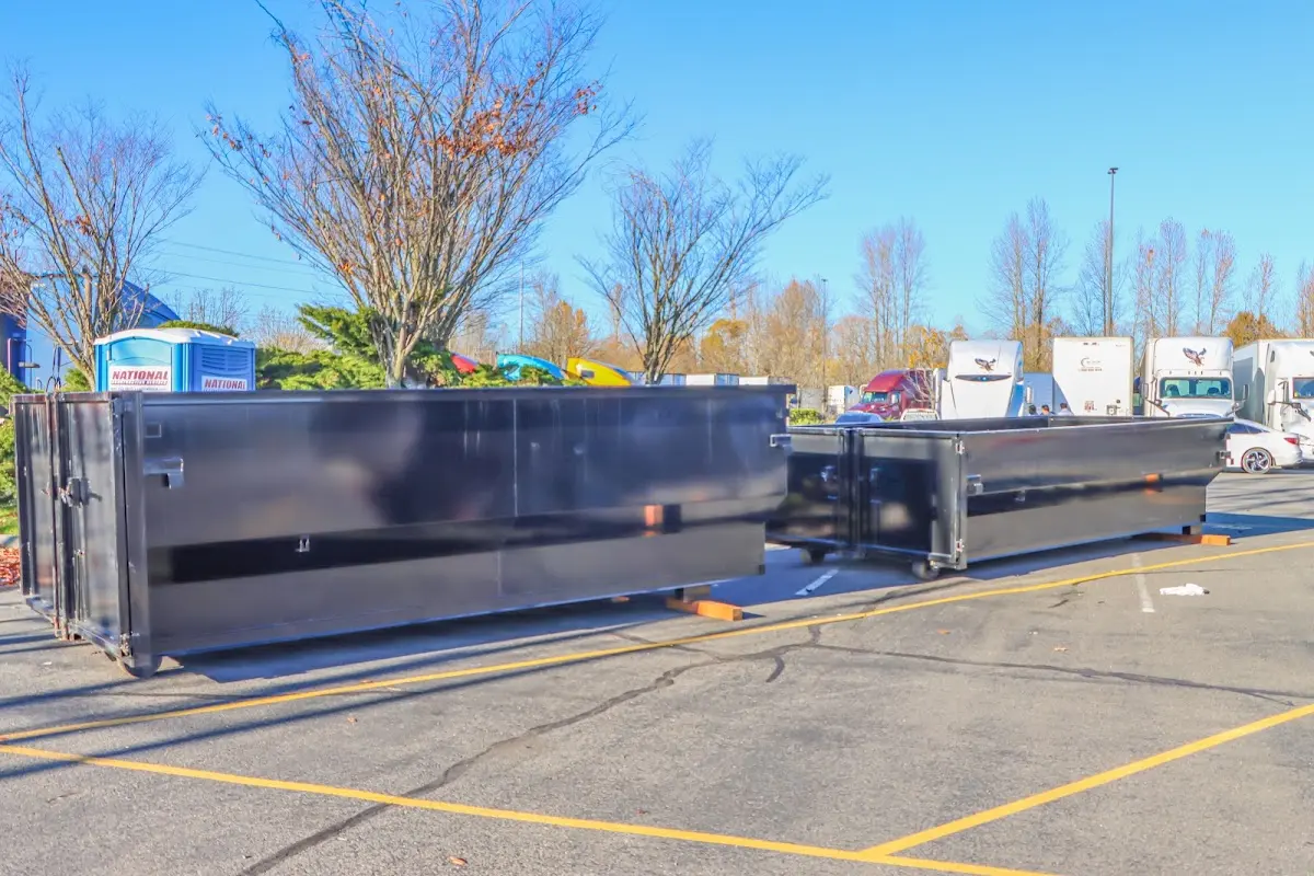 Professional dumpster rental service with roll-off container on residential driveway in Scio